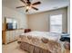 Bright bedroom features a ceiling fan, dresser, and sunny window view at 5800 Oakdale Se Rd # 147, Mableton, GA 30126