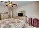 Bedroom with ceiling fan, dresser, and a view of the landing and stairs at 5800 Oakdale Se Rd # 147, Mableton, GA 30126