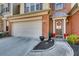 Close-up of a well-maintained townhome exterior with a prominent front door and attached garage at 5800 Oakdale Se Rd # 147, Mableton, GA 30126