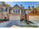 Inviting townhome with a welcoming front entrance and a two-car garage, framed by manicured landscaping at 5800 Oakdale Se Rd # 147, Mableton, GA 30126