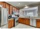 Modern kitchen with stainless appliances, wooden cabinets, and open view to the dining area at 5800 Oakdale Se Rd # 147, Mableton, GA 30126