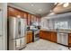Modern kitchen with stainless appliances, wooden cabinets, and open view to the dining area at 5800 Oakdale Se Rd # 147, Mableton, GA 30126