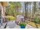 Back patio area with a grill, seating and wooded views to the rear at 5800 Oakdale Se Rd # 147, Mableton, GA 30126