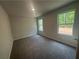 A bright bedroom with large windows, soft carpeting, and neutral paint, perfect for relaxation and rest at 75 Emerald Ln, Covington, GA 30014