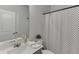 This well-lit bathroom includes a sink, mirror, and shower at 1258 Ainsworth Aly # 46, Sugar Hill, GA 30518