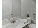 This modern bathroom features a large mirror, toilet, and shower at 1258 Ainsworth Aly # 46, Sugar Hill, GA 30518