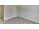 This carpeted bedroom features a door and neutral-toned walls at 1258 Ainsworth Aly # 46, Sugar Hill, GA 30518