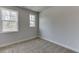Bright bedroom featuring two windows and neutral carpeting with white trim at 1258 Ainsworth Aly # 46, Sugar Hill, GA 30518
