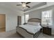 Comfortable bedroom with a tray ceiling, ceiling fan and a large window to the yard at 1258 Ainsworth Aly # 46, Sugar Hill, GA 30518