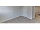 Minimalist bedroom featuring neutral carpeting and paint, with access to a hallway and room at 1258 Ainsworth Aly # 46, Sugar Hill, GA 30518