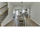 View of dining room and kitchen with modern lighting fixtures and wood floors at 1258 Ainsworth Aly # 46, Sugar Hill, GA 30518