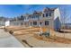 Newly constructed townhomes with modern brick exteriors and landscaped grounds offer a vibrant community living experience at 1258 Ainsworth Aly # 46, Sugar Hill, GA 30518