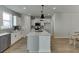 Well-lit kitchen island with barstool seating, modern appliances, and ample counter space at 1258 Ainsworth Aly # 46, Sugar Hill, GA 30518