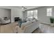 Bright living room with large windows, hardwood floors, and a cozy fireplace at 1258 Ainsworth Aly # 46, Sugar Hill, GA 30518