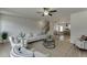 Open-concept living room view showcasing the wood floors, fireplace, kitchen, and staircase at 1258 Ainsworth Aly # 46, Sugar Hill, GA 30518