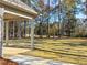 View of the expansive backyard and well-maintained lawn from the covered porch showing the outdoor space at 1874 Mcgarity Rd, Mcdonough, GA 30252