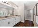 Modern bathroom with double vanity, granite counters, dark wood floors and glass enclosed shower at 1874 Mcgarity Rd, Mcdonough, GA 30252