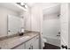 Bright bathroom featuring granite counters, white cabinets, and modern fixtures at 1874 Mcgarity Rd, Mcdonough, GA 30252