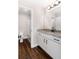 Bright bathroom featuring granite counters, white cabinets, and modern fixtures at 1874 Mcgarity Rd, Mcdonough, GA 30252