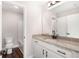 Bright bathroom featuring granite counters, white cabinets, and modern fixtures at 1874 Mcgarity Rd, Mcdonough, GA 30252