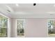 Bright bedroom featuring a tray ceiling and multiple windows at 1874 Mcgarity Rd, Mcdonough, GA 30252