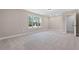 Large bedroom with soft carpet, natural light, and doorway access to the hallway at 1874 Mcgarity Rd, Mcdonough, GA 30252