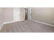 Cozy bedroom featuring neutral walls, carpeted flooring, and doorway views to the staircase at 1874 Mcgarity Rd, Mcdonough, GA 30252