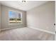 Bright bedroom with neutral walls, plush carpeting, and a large window offering a serene outdoor view at 1874 Mcgarity Rd, Mcdonough, GA 30252