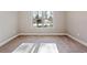 Bedroom features neutral walls, carpet, and a large window with natural light at 1874 Mcgarity Rd, Mcdonough, GA 30252