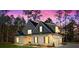 Beautifully landscaped modern home with inviting front entrance and warm lighting at 1874 Mcgarity Rd, Mcdonough, GA 30252