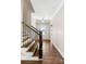 Inviting home entrance showcasing wood floors, stairs with black iron railings, and a bright, welcoming atmosphere at 1874 Mcgarity Rd, Mcdonough, GA 30252