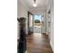 Foyer with wood-look floors and a view of the open front door and outdoor landscape, bright and welcoming at 1874 Mcgarity Rd, Mcdonough, GA 30252