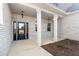 Inviting front porch featuring brick columns and a black front door, offering a warm welcome to guests and residents at 1874 Mcgarity Rd, Mcdonough, GA 30252