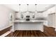 Kitchen featuring an island with granite countertops, white cabinets and pendant lighting at 1874 Mcgarity Rd, Mcdonough, GA 30252