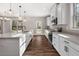 Kitchen with a large island with seating, stainless steel appliances, and hardwood floors at 1874 Mcgarity Rd, Mcdonough, GA 30252