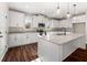 Modern kitchen featuring white cabinets, stainless steel appliances, granite countertops, and a spacious center island at 1874 Mcgarity Rd, Mcdonough, GA 30252
