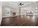 Spacious living room with a cozy fireplace and large windows that let in natural light, flowing into an open-concept kitchen at 1874 Mcgarity Rd, Mcdonough, GA 30252