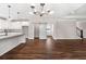 Spacious living area with dark hardwood floors, custom pantry and modern lighting at 1874 Mcgarity Rd, Mcdonough, GA 30252