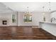 Large living space featuring a fireplace, large windows, hardwood floors and kitchen with pendant lighting at 1874 Mcgarity Rd, Mcdonough, GA 30252