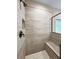 Walk-in shower with dark trim, bench, stone tile and mosaic floors at 1874 Mcgarity Rd, Mcdonough, GA 30252