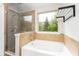 Bathroom features a soaking tub and glass-enclosed shower, offering a spa-like experience at 2167 Crestridge Ne Trl, Brookhaven, GA 30329