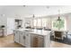 Open floor plan kitchen features an island with stainless steel dishwasher, adjacent to dining and living areas at 2167 Crestridge Ne Trl, Brookhaven, GA 30329