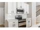 Well-equipped kitchen showcases stainless steel oven, microwave, sleek white cabinets and subway tile at 2167 Crestridge Ne Trl, Brookhaven, GA 30329