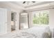 Bright main bedroom features a large window, tray ceiling, and ensuite bathroom access at 2167 Crestridge Ne Trl, Brookhaven, GA 30329