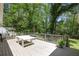 View of a spacious wooden deck featuring a table, potted plant, and serene wooded backdrop at 2515 Ridgewood Nw Rd, Atlanta, GA 30318