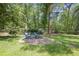 Backyard featuring mature trees and a fire pit with Adirondack chairs at 2515 Ridgewood Nw Rd, Atlanta, GA 30318