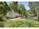 Expansive backyard with lush lawn, mature trees, deck, and inviting outdoor seating area at 2515 Ridgewood Nw Rd, Atlanta, GA 30318