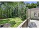 Scenic view from the deck showcasing the expansive backyard, mature trees, and fire pit area at 2515 Ridgewood Nw Rd, Atlanta, GA 30318