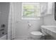 Bathroom featuring a shower-tub, window, toilet, and stylish sink at 2515 Ridgewood Nw Rd, Atlanta, GA 30318