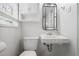 Bathroom featuring a sleek sink, toilet, storage, and modern mirror at 2515 Ridgewood Nw Rd, Atlanta, GA 30318